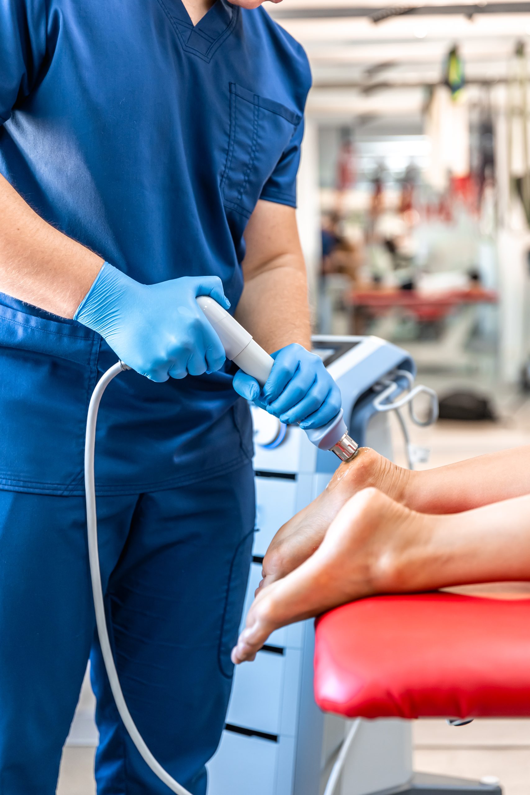 Patient getting non-surgical treatment with shock waves for plantar fasciitis.